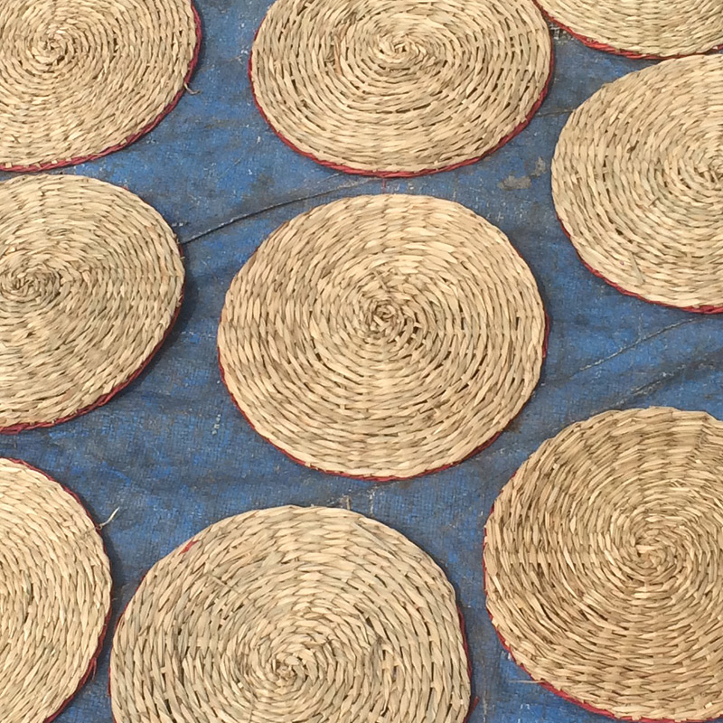 Vietnamese artisan handweaving natural seagrass mats with quality processing