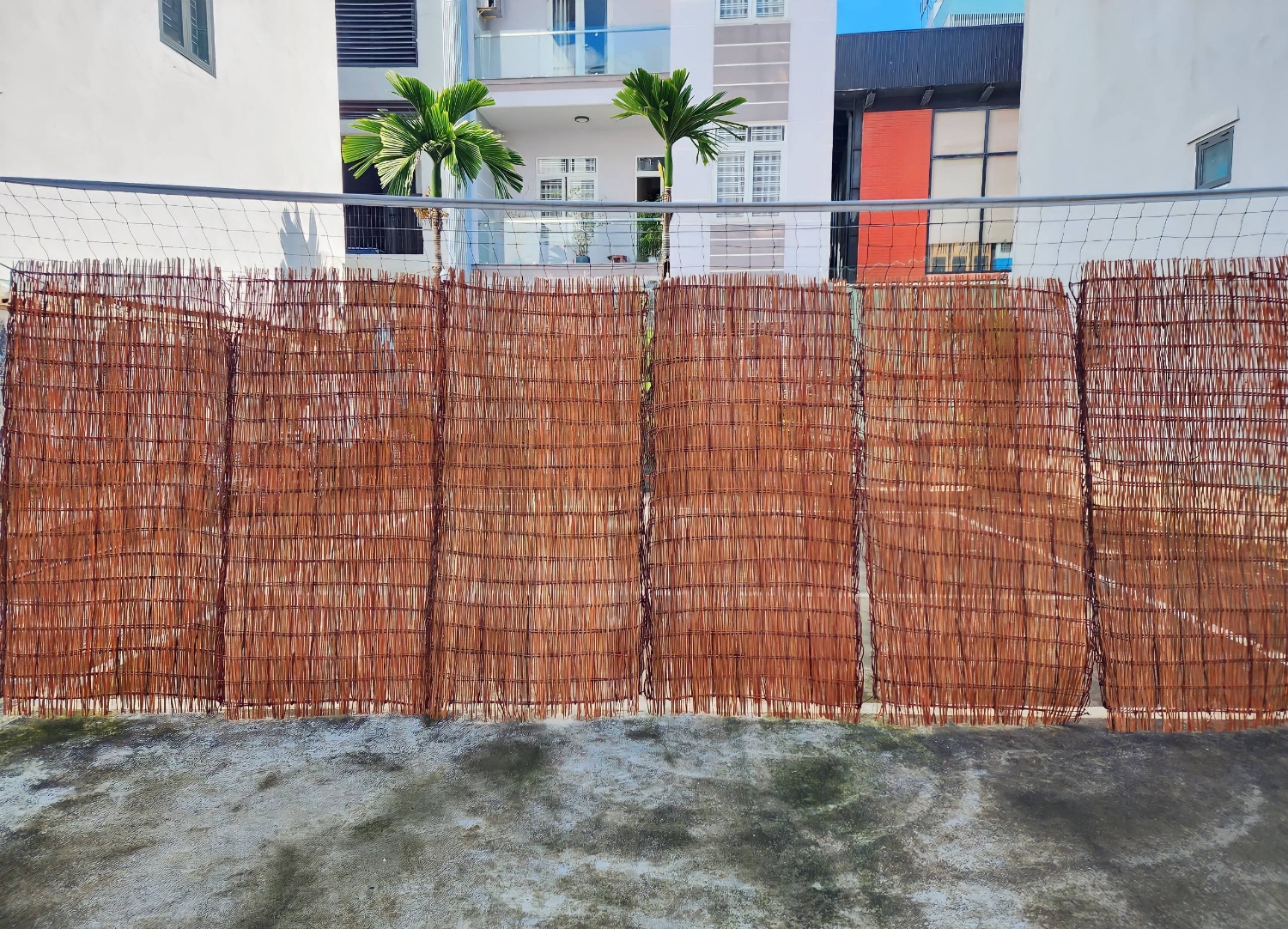Woven willow fence panels installed for garden boundary privacy screening